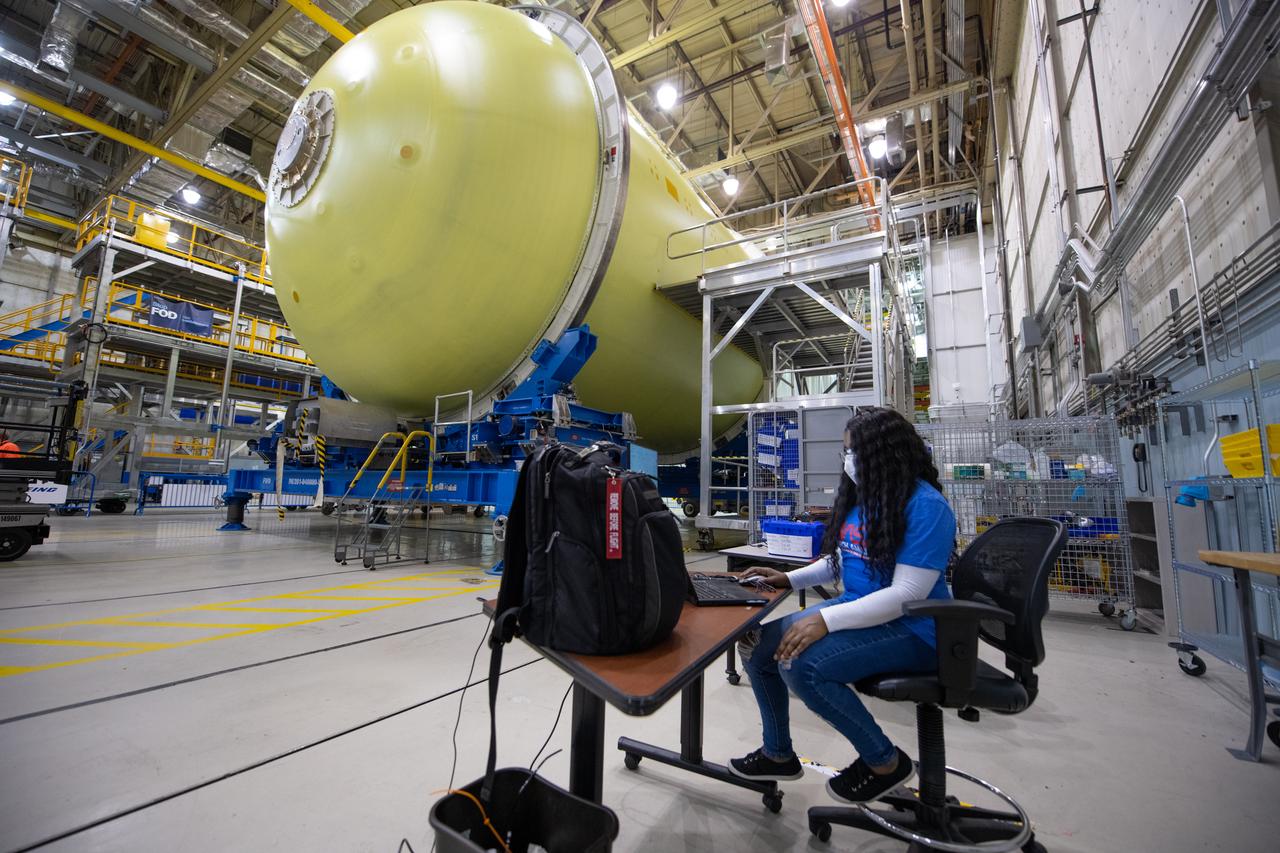 Employees wear personal protective gear at  Michoud Assembly Facility as the facility transitioned to Stage 3 of NASA’s Framework for Return To On-Site Work. Employees wear the appropriate personal protective equipment (PPE) and/or cloth face coverings as required for assigned tasks. Access to the facility is limited to authorized personnel working on mission-critical tasks that must be conducted onsite. Mission-critical tasks include slowly and methodically resuming Space Launch System (SLS) Core Stage and Orion production activities, particularly critical path deliverables to support the Artemis Program, at a pace that limits personnel and follows federal guidelines for social distancing and use of personal protective equipment such as face masks. For more information about SLS, visit nasa.gov/sls.